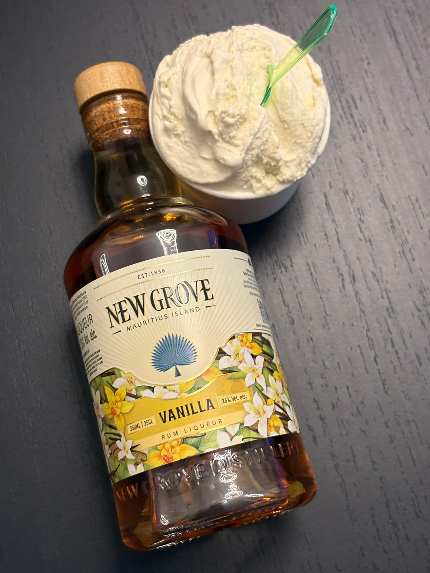 Homemade vanilla ice cream next to a bottle of vanilla rum