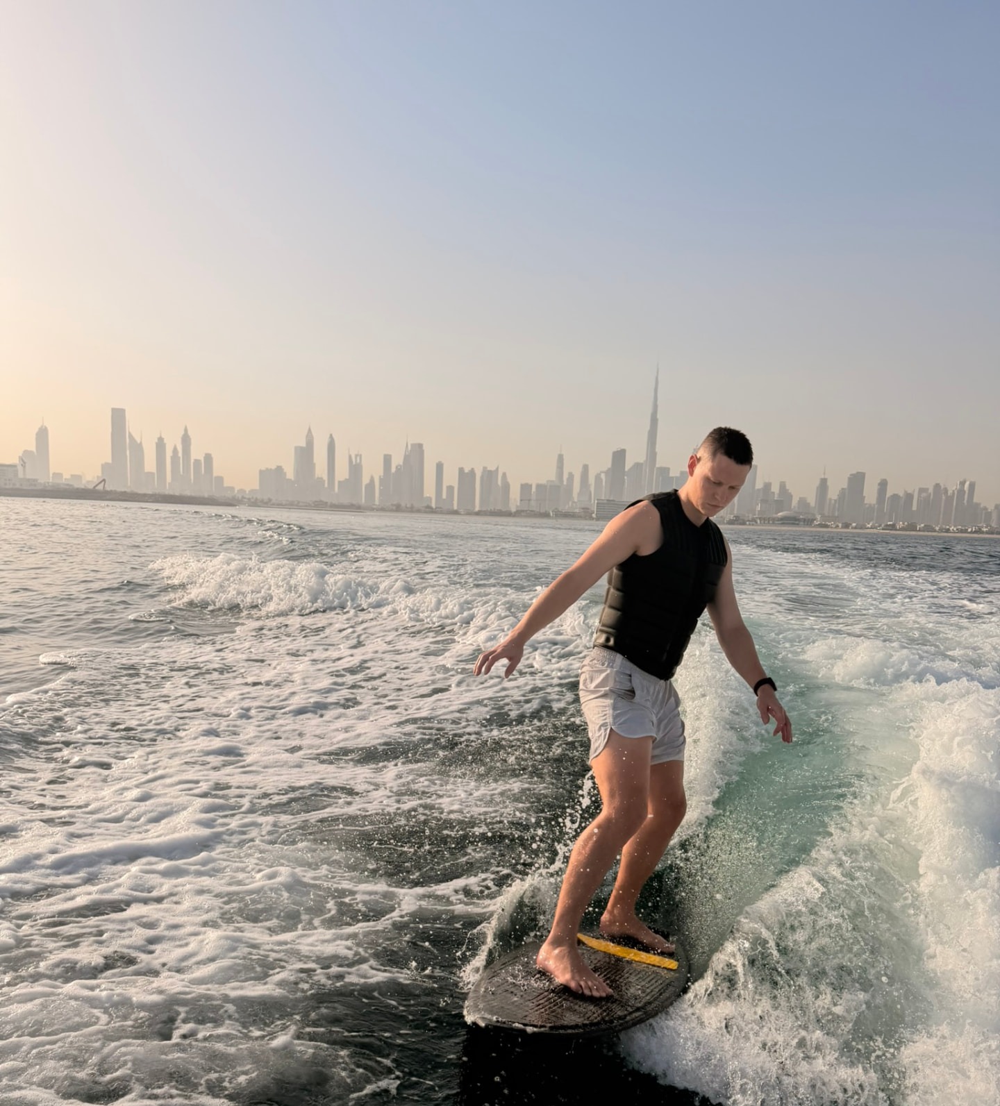 Fabian Küster wakesurfing with the Dubai skyline behind