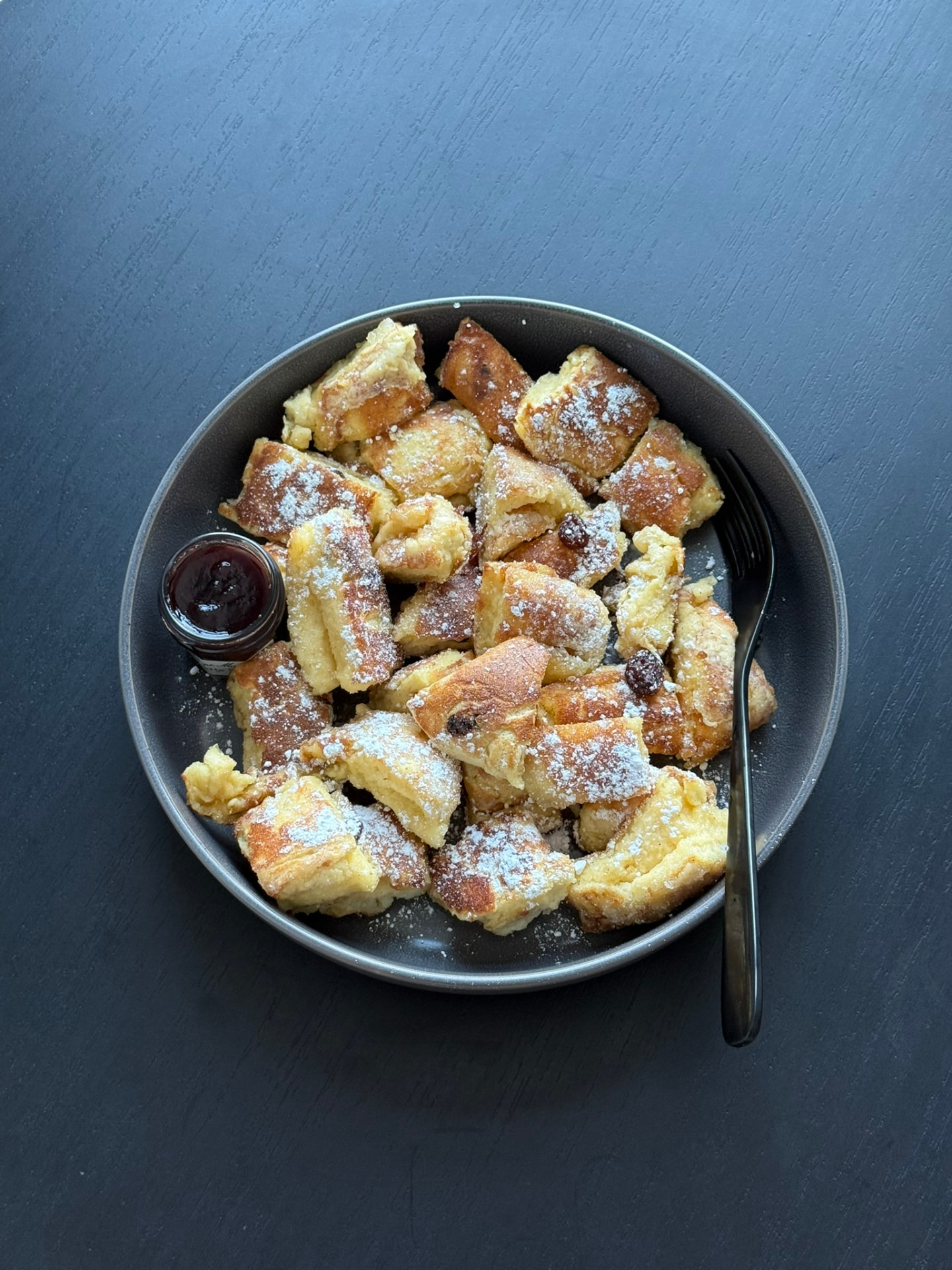 Kaiserschmarrn with icing sugar and plum compote