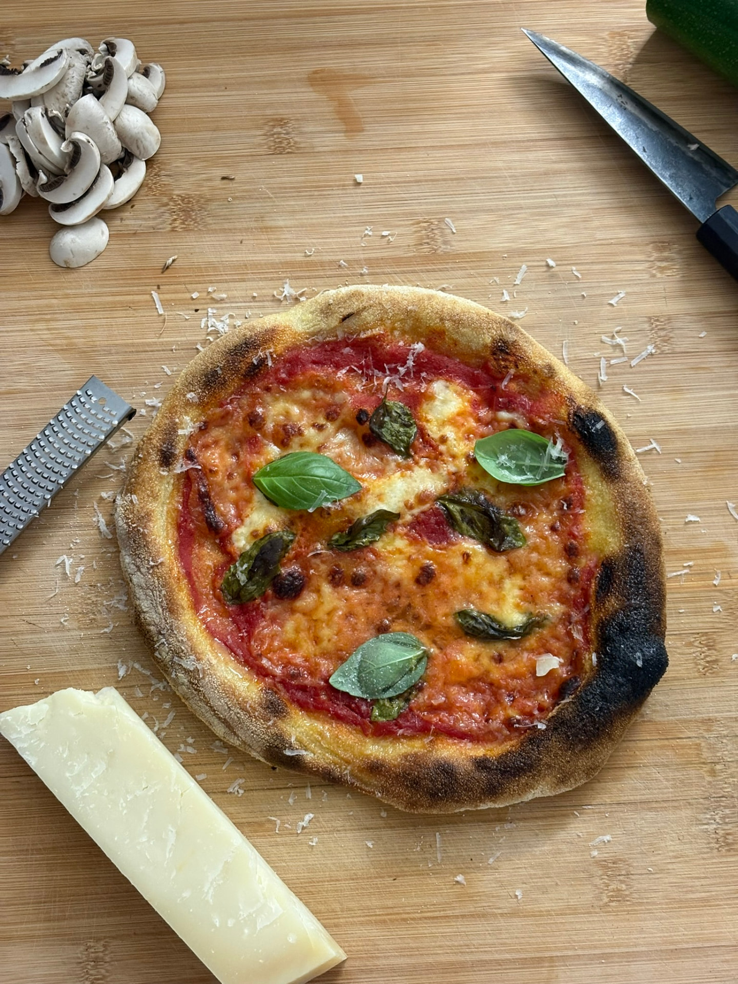 Homemade pizza margherita with basil on a wooden board