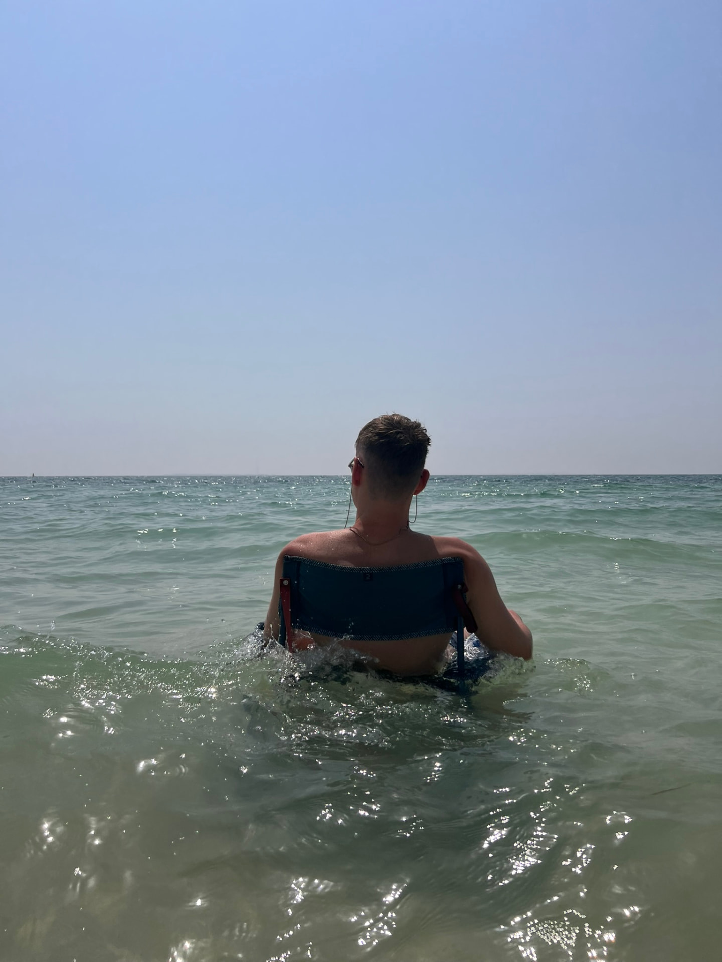 Fabian Küster sitting on a chair in the sea