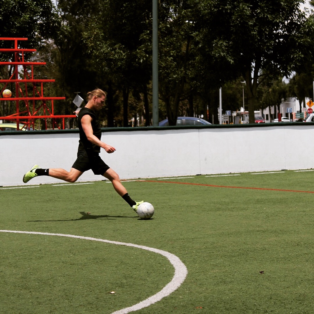Fabian Küster taking a shot on an artificial turf pitch